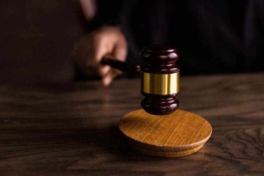 Close-up of a judge's gavel on a wooden block, symbolizing justice and law.
